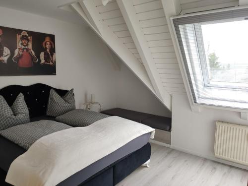 a bedroom with a bed and a large window at Bollenhut Superior in Lenzkirch