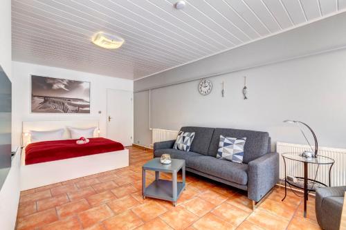 a living room with a bed and a couch at Bungalow Jonas in Trassenheide
