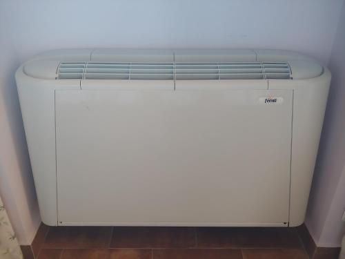 a white refrigerator sitting in a corner of a room at Tenuta Bellaprima CALTAGIRONE in Niscemi