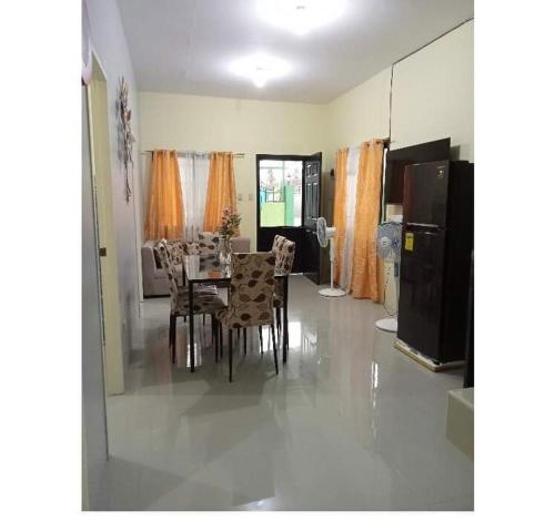 a dining room with a table and chairs at Sunrise Enterprise in Tagum