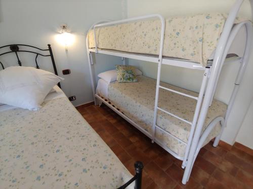 a bedroom with two bunk beds and a bed at Tenuta Bellaprima CALTAGIRONE in Niscemi