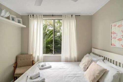 a bedroom with a white bed and a window at Bright 1 Bedroom Apartment in Lane Cove in Sydney