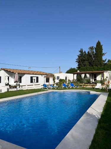 a swimming pool in front of a house at Casa Maria Marta in Cádiz