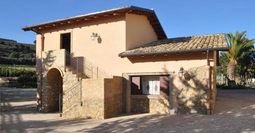 a small house with a staircase on the side of it at Tenuta Bellaprima CALTAGIRONE in Niscemi