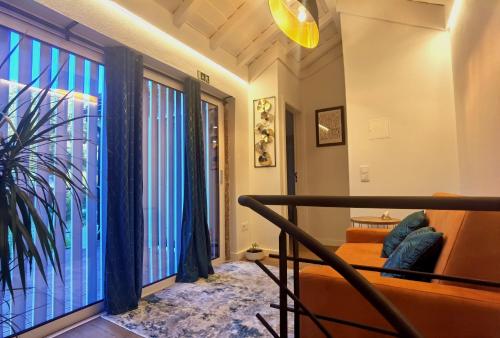 a living room with a couch and a large window at Mill House by the River in Arcos de Valdevez