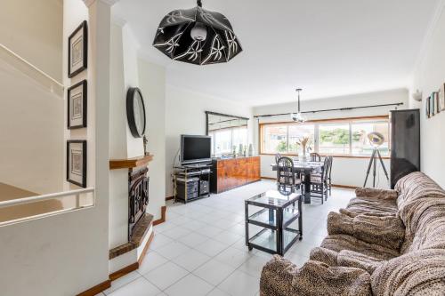 a living room with a couch and a table at Vila do Conde Sea House in Vila do Conde