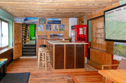 a room with wooden walls and a counter with a table at Aqualand chata - Športové a výcvikové stredisko ZPS in Dedinky