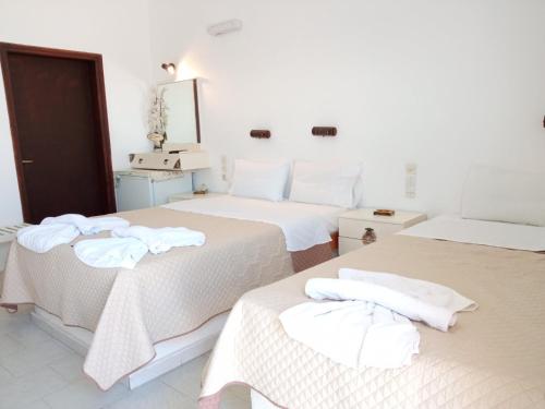 a hotel room with two beds with towels on them at Psiloritis in Kalamaki Heraklion
