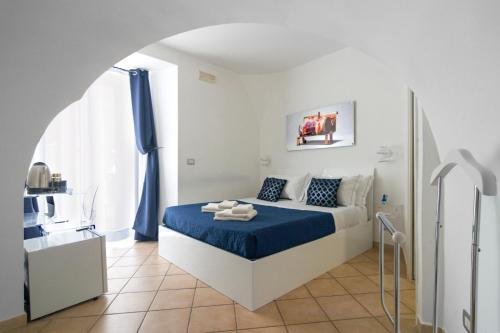 a bedroom with a bed with a blue blanket at Maison Du La Rua in Naples