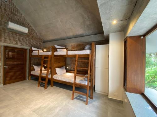 a room with three bunk beds in it at Ostel In in Puducherry