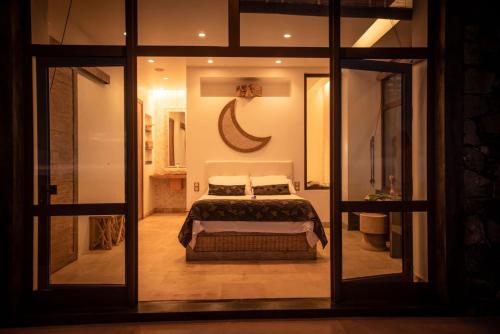 a bedroom with a bed and a large glass window at Villa - Cantinho do Paraíso in Santo Espírito