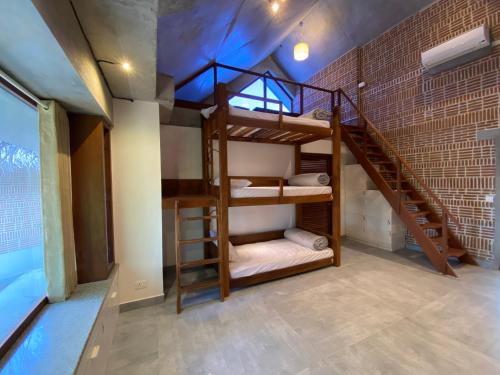a room with two bunk beds and a staircase at Ostel In in Puducherry