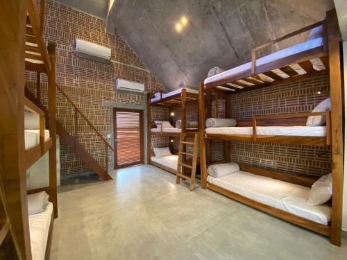 a room with four bunk beds and a staircase at Ostel In in Puducherry