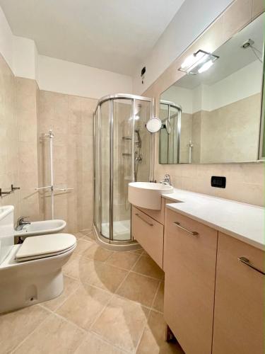 a bathroom with a shower and a toilet and a sink at Sunset Boutique Apartment in Marina di Massa