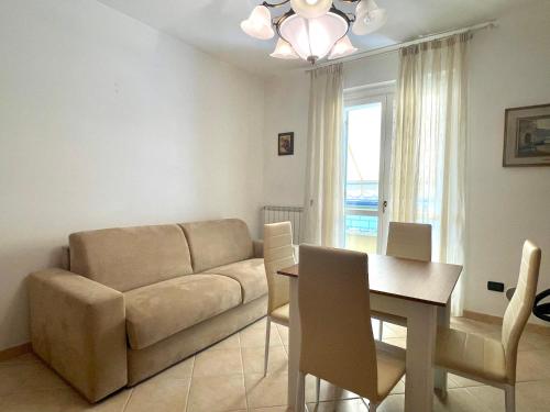 a living room with a couch and a table at Sunset Boutique Apartment in Marina di Massa