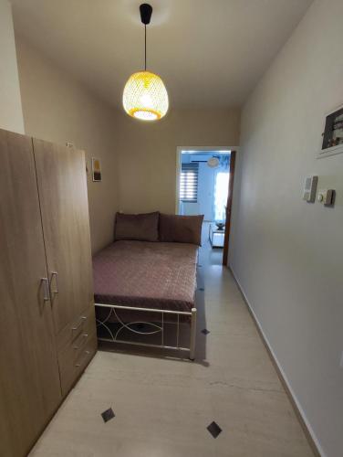 a small room with a bed in the middle of it at EM.MA HOME in Heraklio