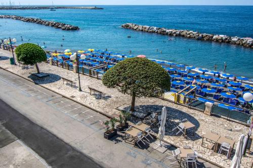 a view of a beach with chairs and umbrellas at Hotel San Pietro Chiavari in Chiavari