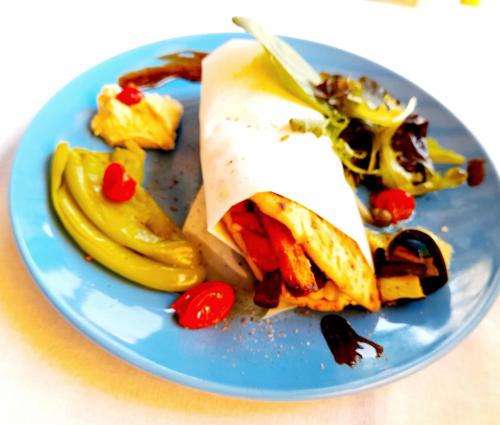 a blue plate with a sandwich and fruit on it at Ble Mavi - Studio for 2 in Vouni