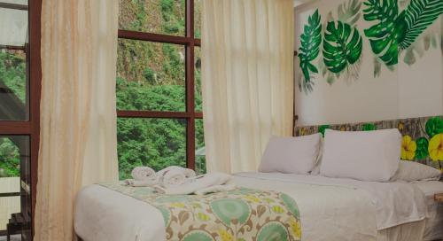 a bedroom with a bed with towels on it at Rupa Rupa High Jungle Eco B&B in Machu Picchu