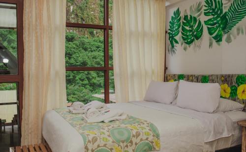 a bedroom with a bed with towels on it at Rupa Rupa High Jungle Eco B&B in Machu Picchu