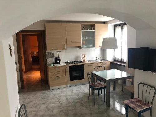 a kitchen with a table and a stove top oven at panoramic sondrio in Sondrio