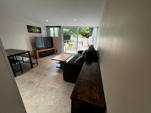 a living room with a couch and a table at Les Cygnes au bord du loing in Montigny-sur-Loing