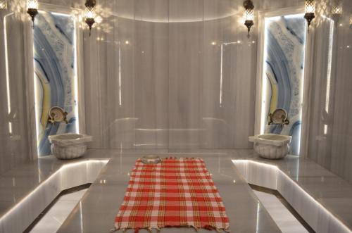 a bathroom with two sinks and a red and white table at Castamar Residence in Bodrum City