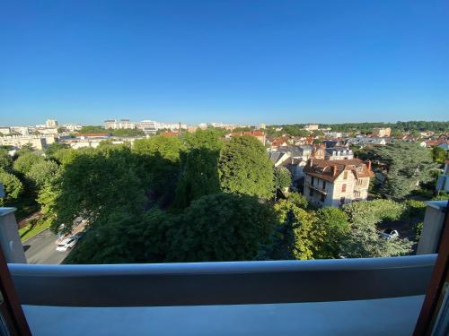 a view of a city from a balcony at Panoramic View Studio - 15 min from Paris in Joinville-le-Pont