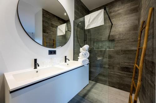 a bathroom with a sink and a mirror at The Reef - Blue Bay Golf & Beach Resort in Willemstad