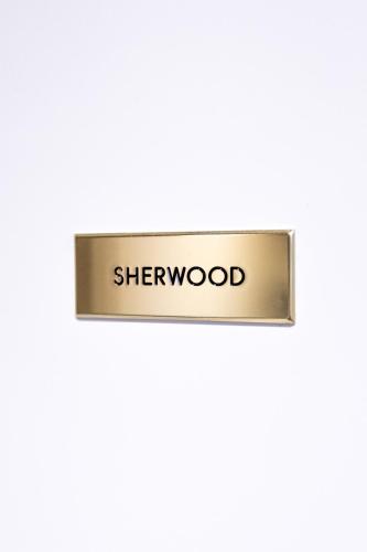 a metal sign with the word shewood on it at Household Settembrini in Milan