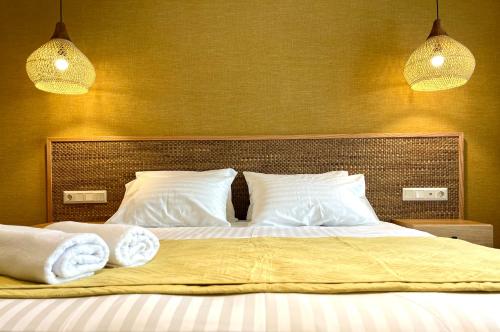 a bedroom with a bed with two towels on it at G&W Luxury Rooms in Athens