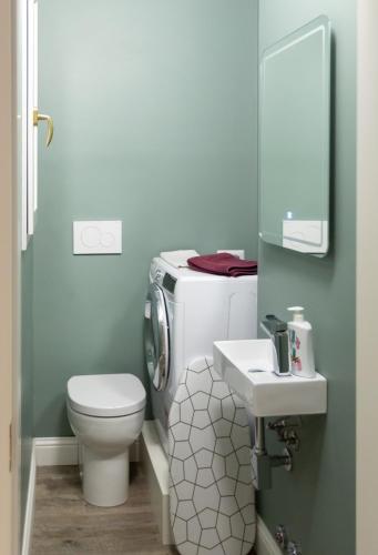 a bathroom with a toilet and a sink at Household Settembrini in Milan