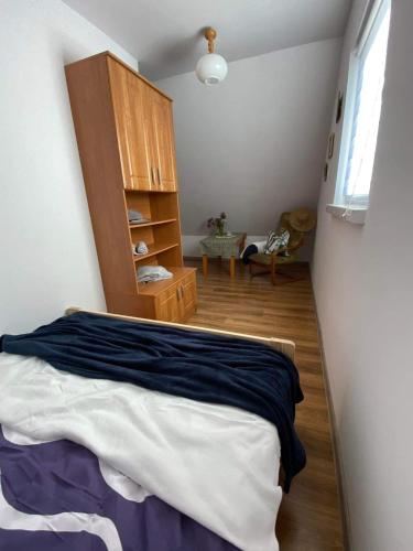 a bedroom with a bed and a wooden cabinet at Willa Paulina in Nadole