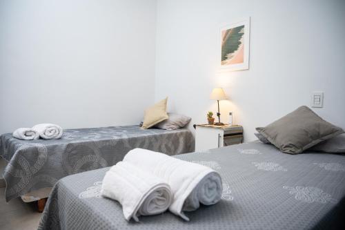 ein Zimmer mit 2 Betten und Handtüchern darauf in der Unterkunft Bienvenido a Café y Vino in Guaymallen