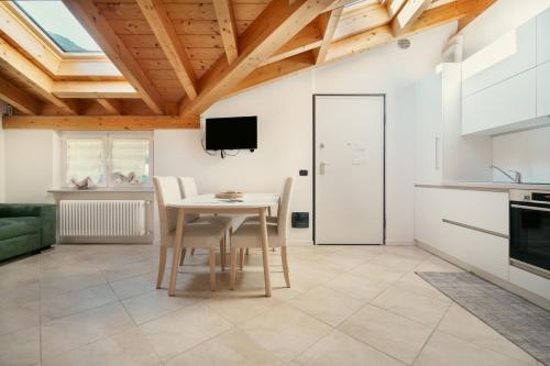 a kitchen and dining room with a table and chairs at Residence Antico Torchio in Dervio