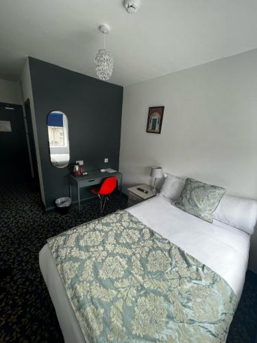 a hotel room with a bed and a desk at Tom Dick and Harriet's Accommodation in Dublin