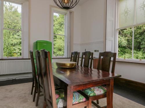 a dining room with a wooden table and chairs at The Residence in Cleator