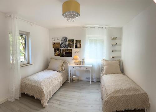 a bedroom with two beds and a desk and a window at Apartments Cassel - mit Smart TV und Parkplätzen - für Singles, Paare, Familien und Gruppen in Kassel