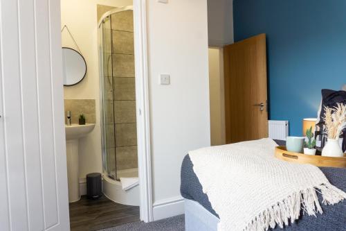 a bedroom with a bed and a mirror at Air Host and Stay - Conningsby House - Beautiful 6 bedroom sleeps 14 minutes to LFC in Liverpool