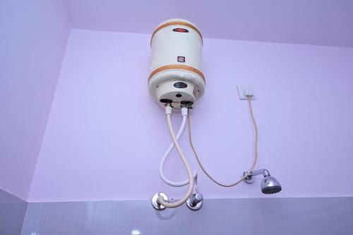 a security light on the wall of a bathroom at Hotel Stay Shine in Mysore