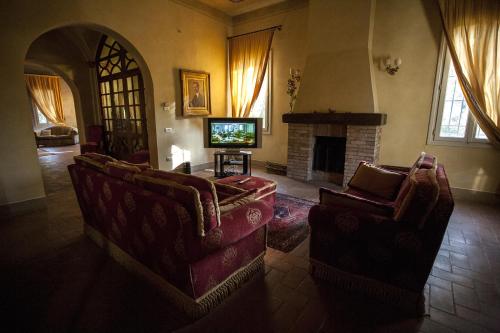 a living room with two couches and a television at R&B Villa Tartaruga in Castelfranco Emilia