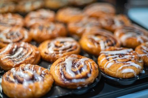 a bunch of donuts sitting on top of a tray at Holiday Inn Express and Suites Atlanta-Johns Creek by IHG in Johns Creek