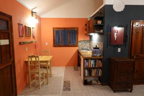 a kitchen with a table and a dining room at Gardenhotel Macan Ché B&B in Izamal