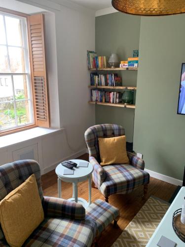 a living room with two chairs and a table at Towerwell in Newburgh