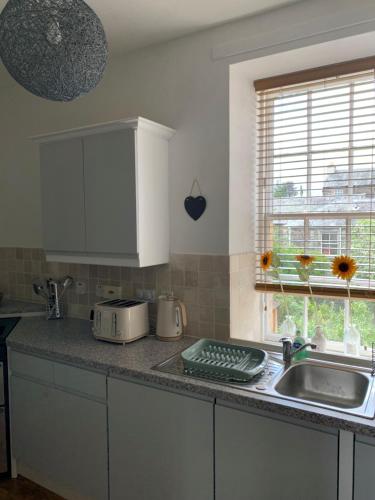 a kitchen with a sink and a counter top at Towerwell in Newburgh
