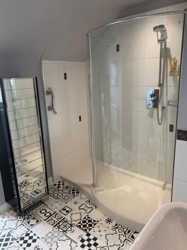 a shower with a glass door in a bathroom at Towerwell in Newburgh