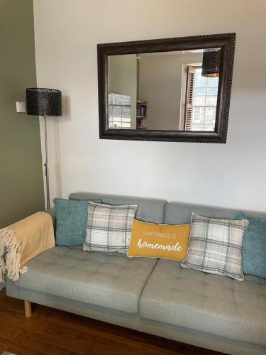a couch in a living room with a mirror at Towerwell in Newburgh