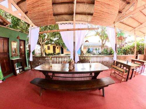 a table and benches in a room with a table and chairs at Pousada Ocazum in Alter do Chao