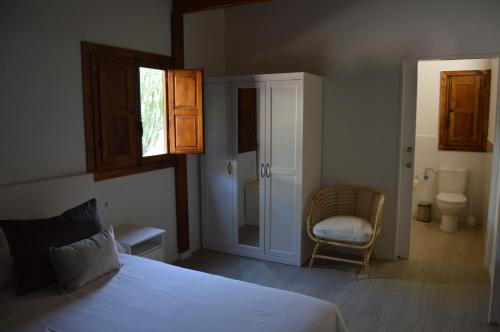 a bedroom with a bed and a chair in it at Villas de Taurito in Taurito