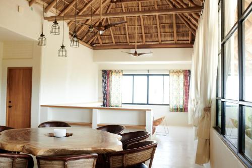 a dining room with a wooden table and chairs at Punta Mita Surf Lodge in Punta Mita